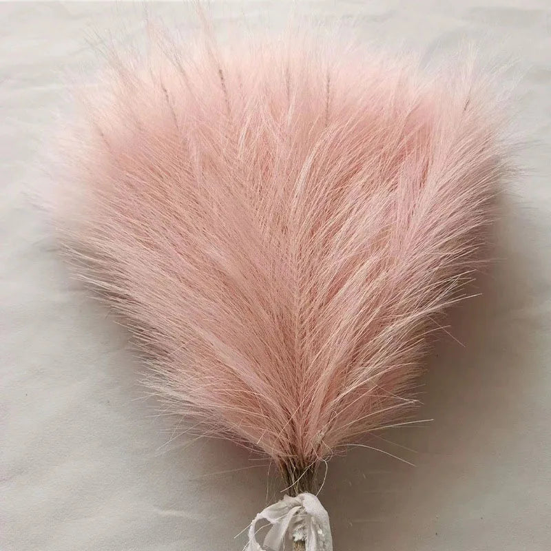 Soft pink artificial pampas grass stems used for boho wedding and home decor