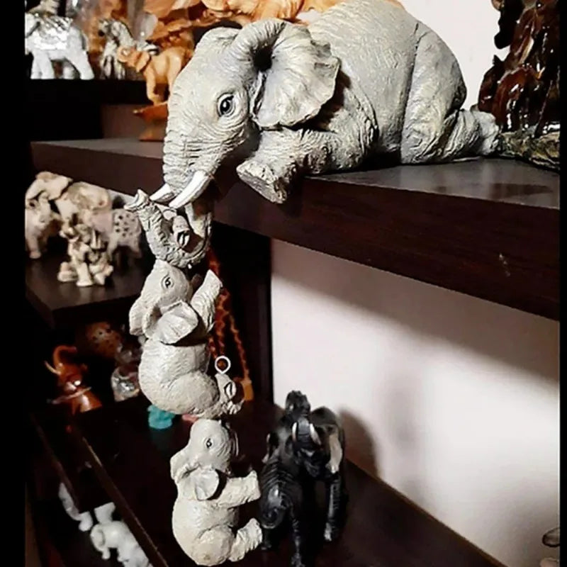 A set of resin figurines depicting a cute elephant hugging a baby.