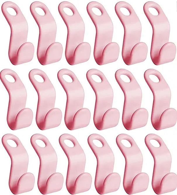 A set of pink space-saving cascading hanger connector hooks for wardrobe organization.
