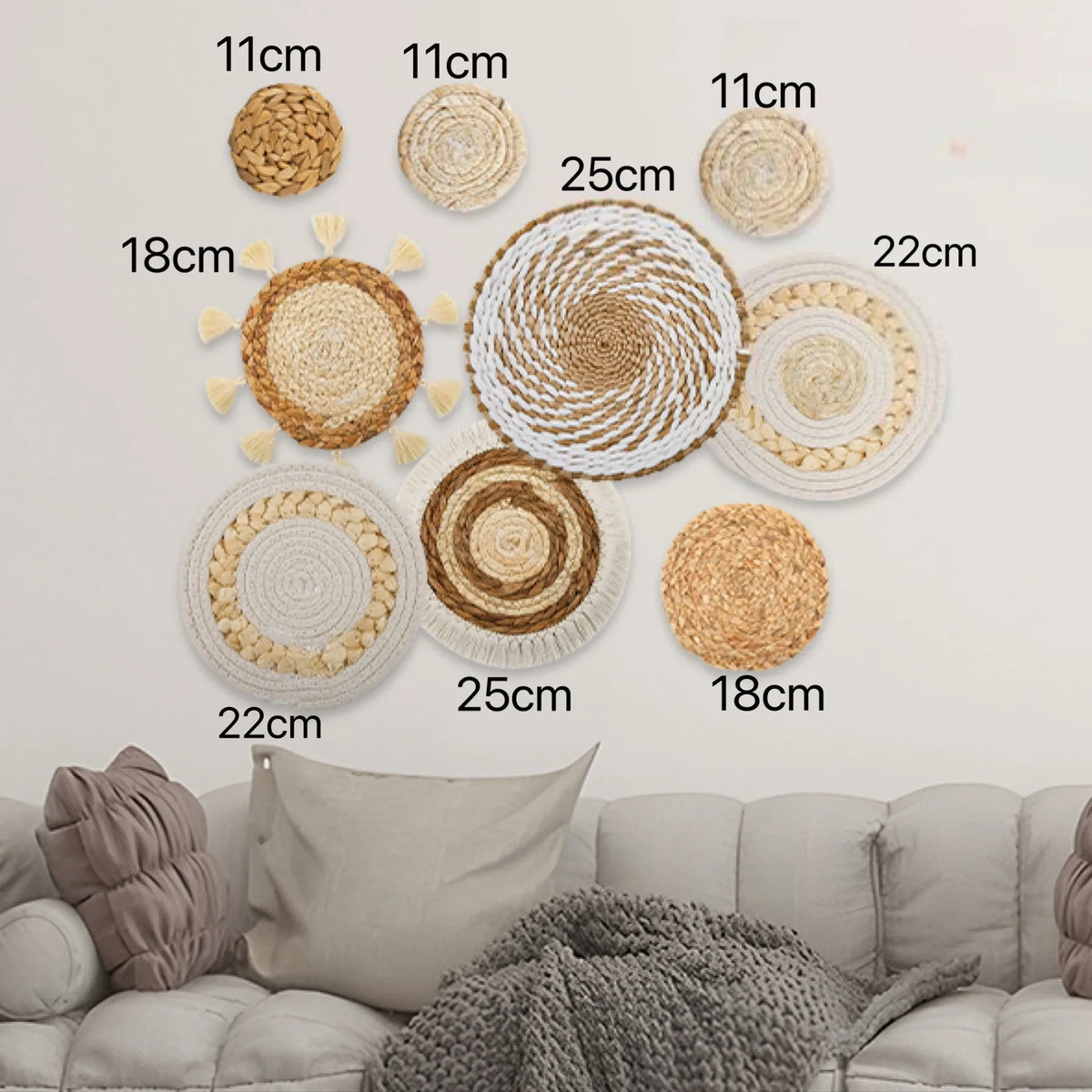 A collection of round boho straw wall hangings with woven tassels displayed on a white wall.