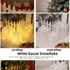 Three clear LED light-up Christmas gift boxes displayed on a white fluffy surface.