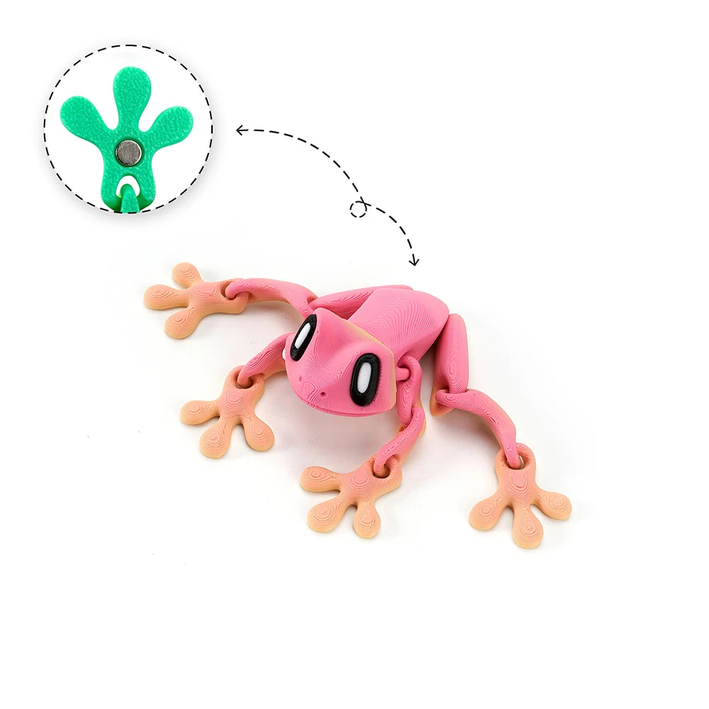 Pink articulated frog magnet with green details, showing its movable limbs.