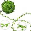 A ball of artificial green climbing vine leaves and a separate trailing vine branch.