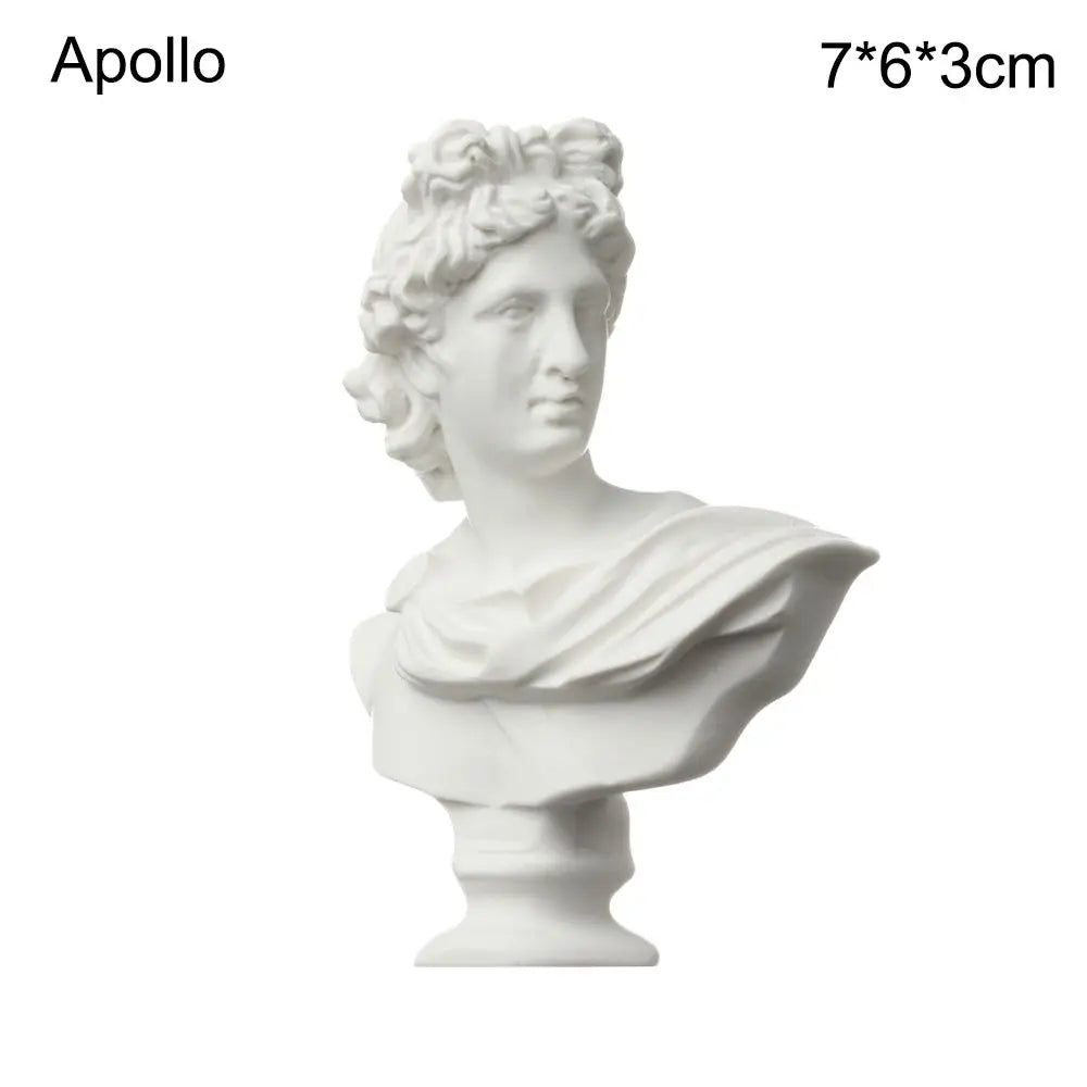 A white plaster bust miniature of Apollo, a classic Greek mythology figure.