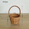 A handwoven rattan storage basket with handles, measuring 8x5.5 cm.