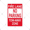 Red and white vintage metal warning sign with text indicating a fire lane no parking tow-away zone