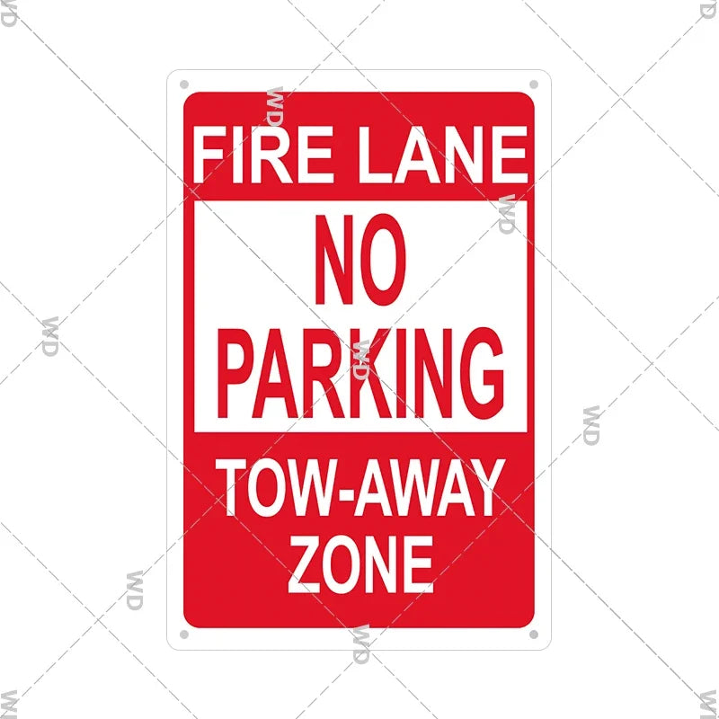 Red and white vintage metal warning sign with text indicating a fire lane no parking tow-away zone