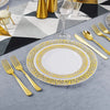 A set of elegant gold rim plastic dinner and dessert plates with a yellow patterned rim displayed on a gray table.