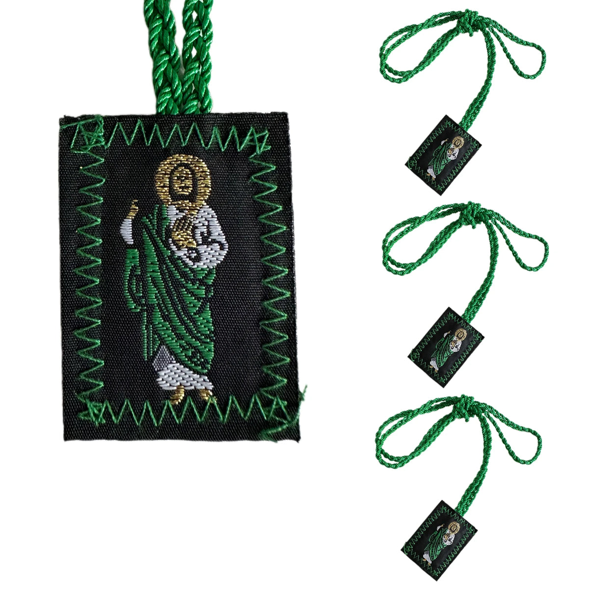 A set of multi-symbol Catholic pendant necklaces featuring a green fabric and gold medallion.