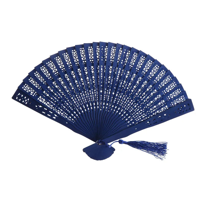 A dark blue hand carved bamboo folding fan with intricate lattice work.