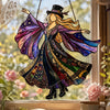 Acrylic hanging suncatcher of a dancing lady with purple and gold wings in a window setting