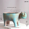 A light blue ceramic cat planter with a long body and pointed ears, showing its dimensions.
