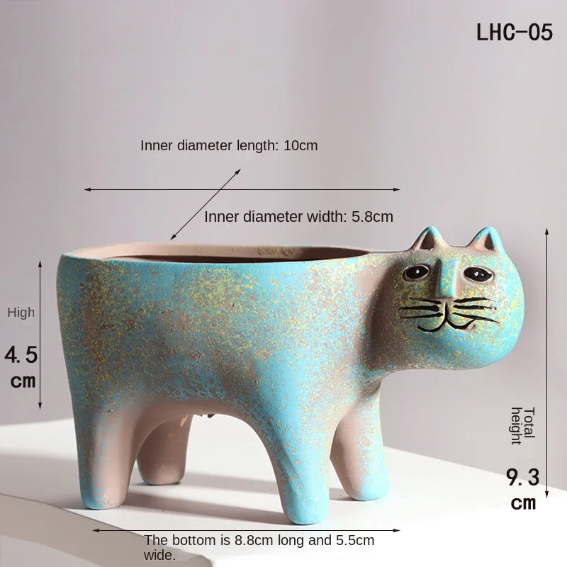 A light blue ceramic cat planter with a long body and pointed ears, showing its dimensions.