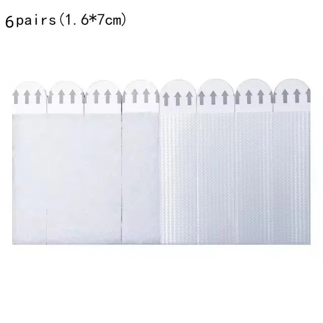 Six pairs of white double-sided adhesive picture hanging strips shown side by side.