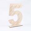A wooden number display stand shaped like the numeral five, used for serving desserts.