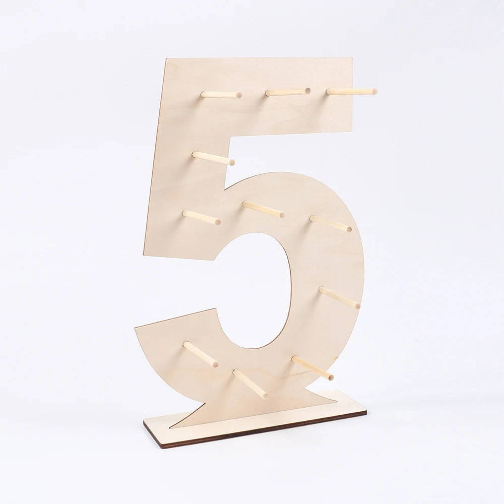 A wooden number display stand shaped like the numeral five, used for serving desserts.