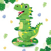A green dinosaur figurine stands on a three-tiered stand decorated with green leaves and small eggs.