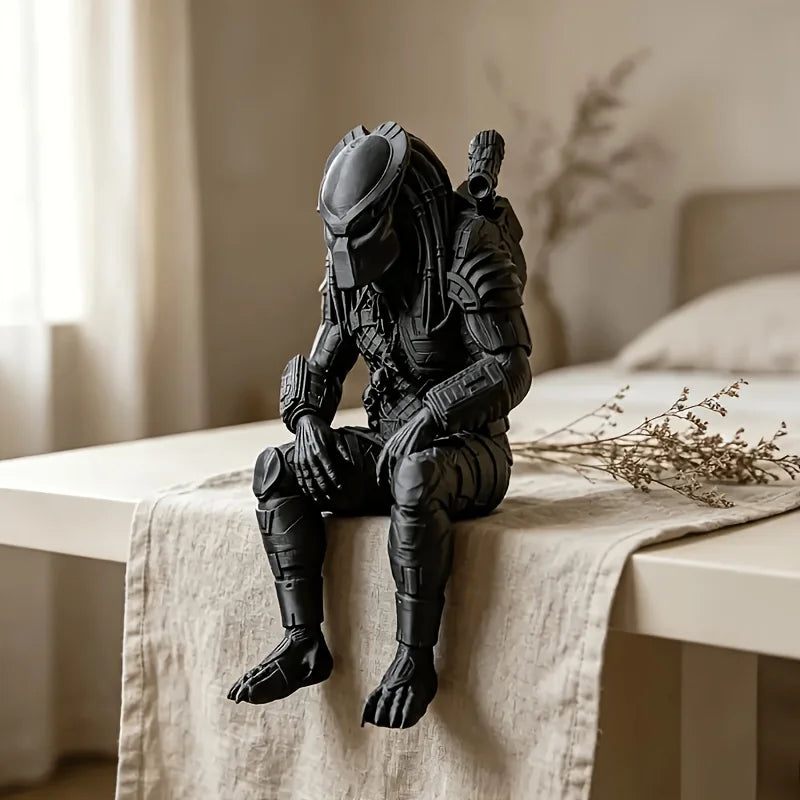 A dark black Interstellar Hunter figurine sculpture sitting on a light-colored cloth next to a window.