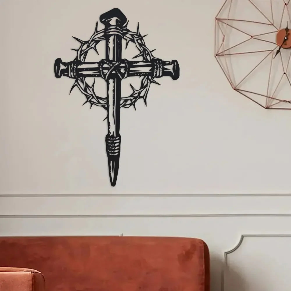 Black metal cross wall art featuring thorns and a pointed design on a white wall.
