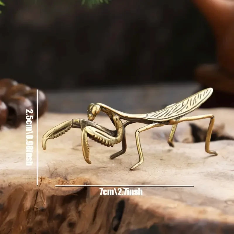 Handcrafted brass rooster figurine with intricate details resting on a wooden surface.