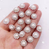 A hand holds a set of 50 pearl rhinestone flatback crystals for DIY crafts and decor.