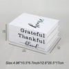 A stack of three modern decorative fake books in white featuring the words grateful thankful and blessed