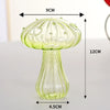 A translucent green glass vase shaped like a mushroom with a stem and cap.