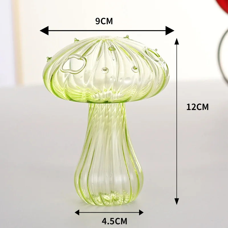 A translucent green glass vase shaped like a mushroom with a stem and cap.