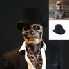 A realistic latex skull mask displayed on a mannequin head, shown alongside the detached mask and a black hat.