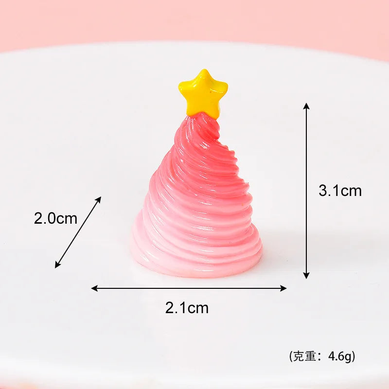 A small, pink, conical Christmas tree charm with a yellow star topper on a white background.