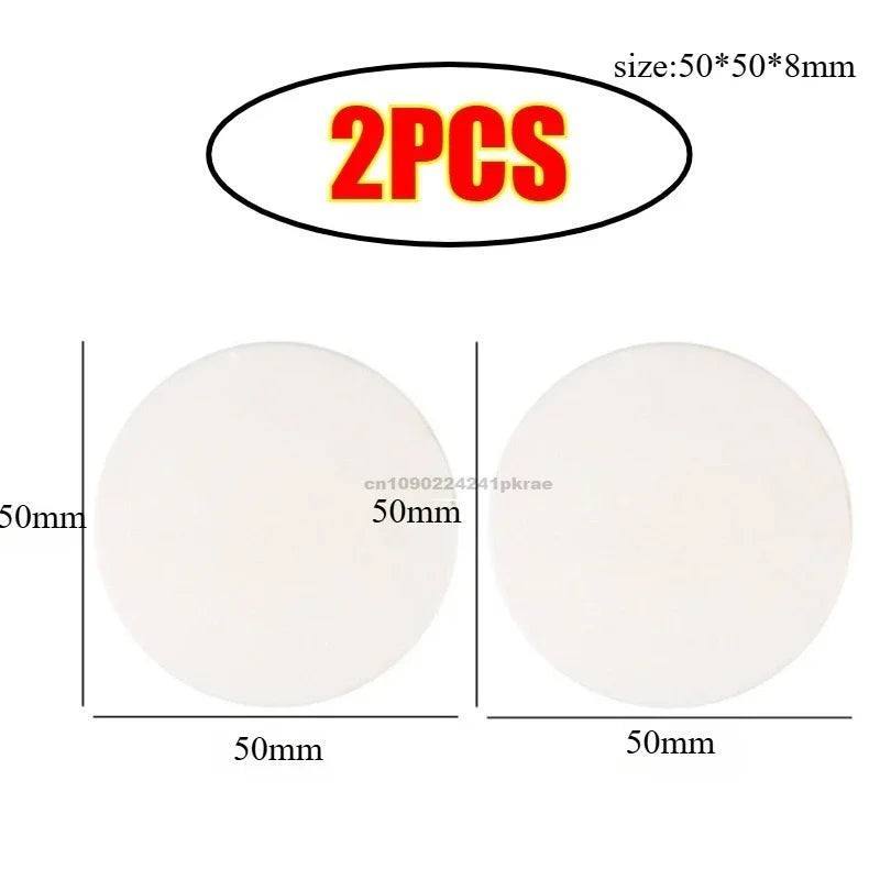 Two white silicone door stoppers or bumpers, each 50mm in diameter and 8mm thick.