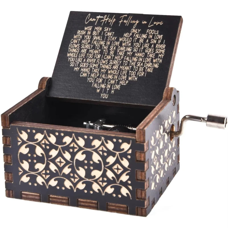 An antique engraved wooden music box with a lid featuring a poem about falling in love