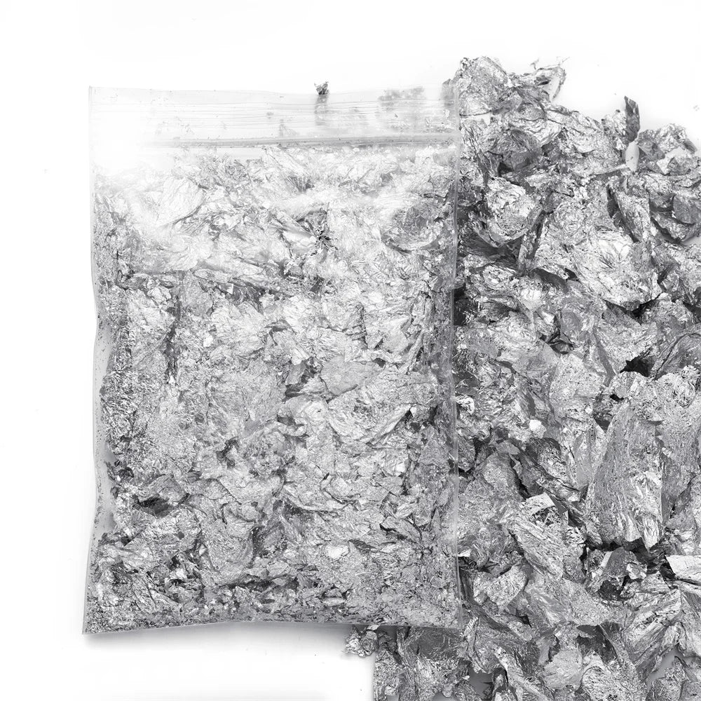 A pile of shiny gold foil flakes used for resin art and jewelry making.
