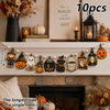 A string of vintage wooden Halloween decorations featuring pumpkins, ghosts, moons, and lanterns displayed on a mantelpiece.