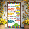 A colorful door banner featuring a book design with text encouraging finding magic where you look.
