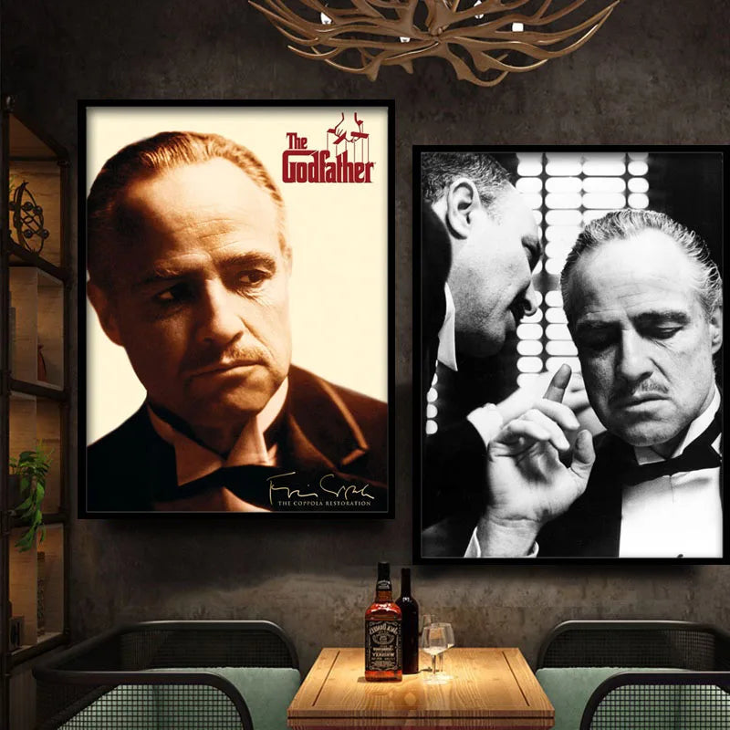 A framed black and white portrait of Marlon Brando as The Godfather hanging on a dark wall.