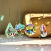 A set of hanging crystal wind chimes featuring teardrop and spherical shapes, sparkling with iridescent colors.