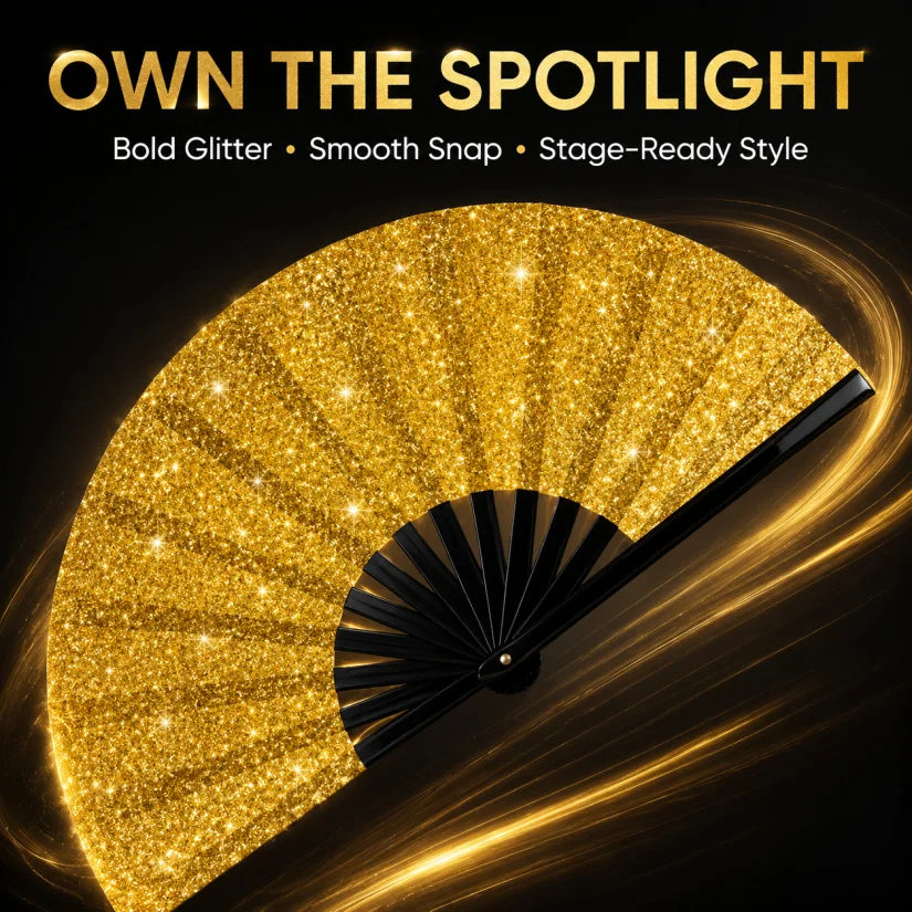 A close-up of a gold glitter hand fan opening to reveal a bright, sparkling surface.