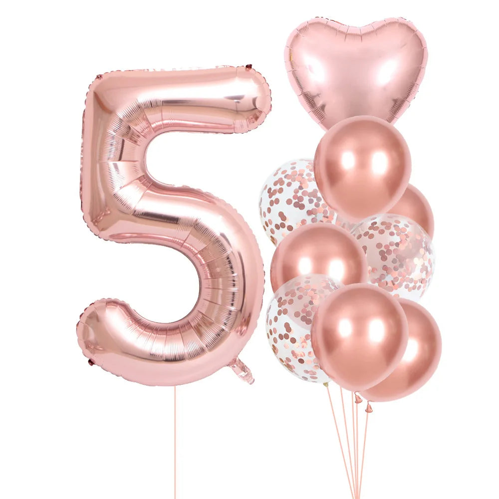 A set of rose gold foil balloons shaped like the number five and heart for party decoration