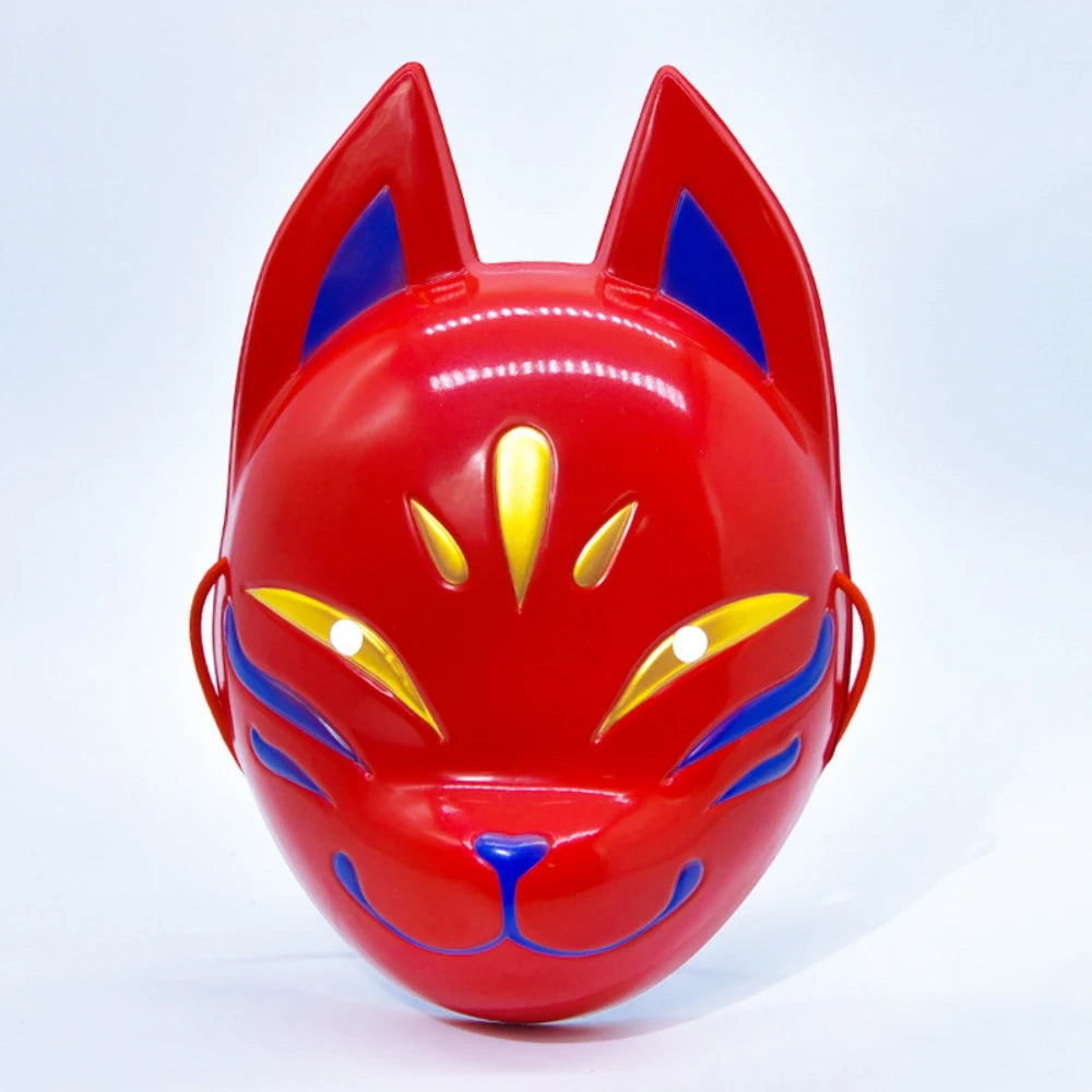 A bright red fox face mask with blue accents and yellow details.