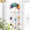A crystal tree of life sun catcher wall decor featuring various colored crystals hanging in a circular frame.