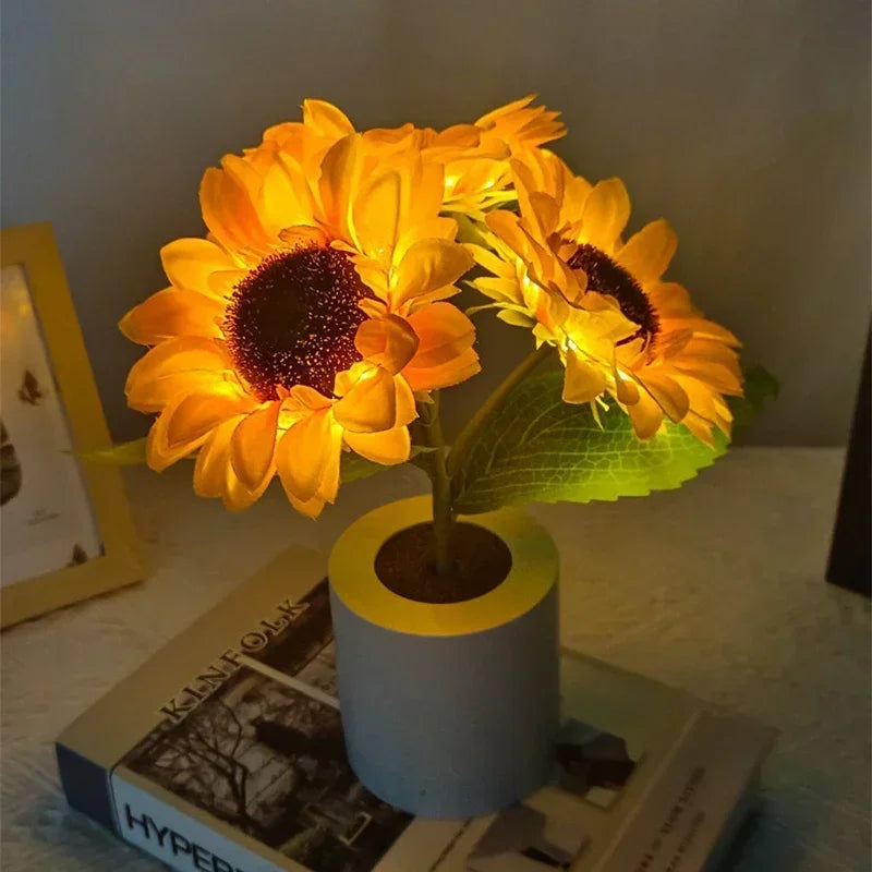 A bright yellow sunflower LED night light illuminates a dark background.