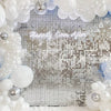 A silver and white sequin glitter party backdrop featuring round and clustered pearl-like decorations.
