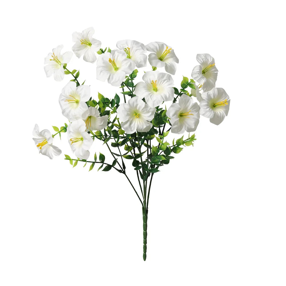 A bouquet of white artificial silk flowers with green leaves.