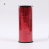 A roll of red glitter curling ribbon used for gift wrapping and party decor.