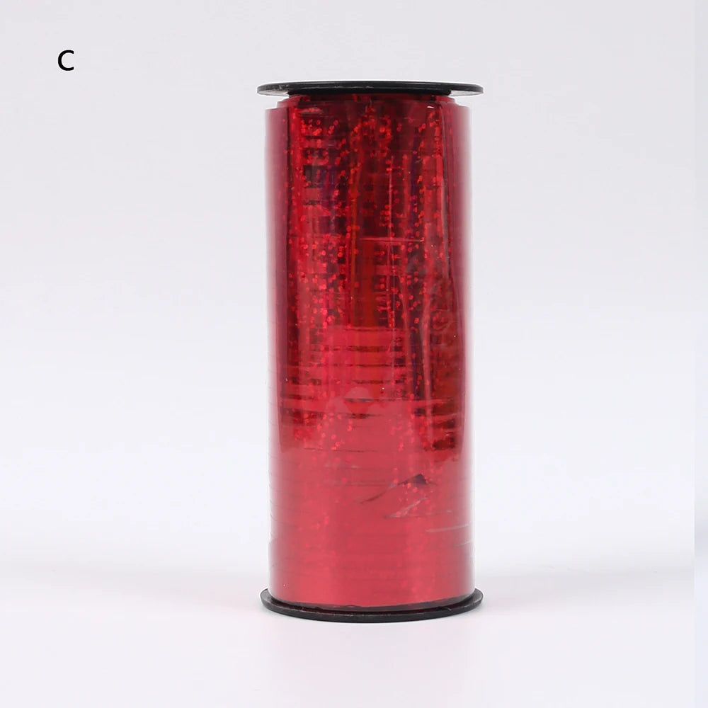 A roll of red glitter curling ribbon used for gift wrapping and party decor.