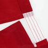 Close-up of a red heavy duty embroidered American flag banner with white trim and stitching.
