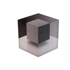 A dark gray cube with a translucent, reflective surface, showing an optical illusion pattern.