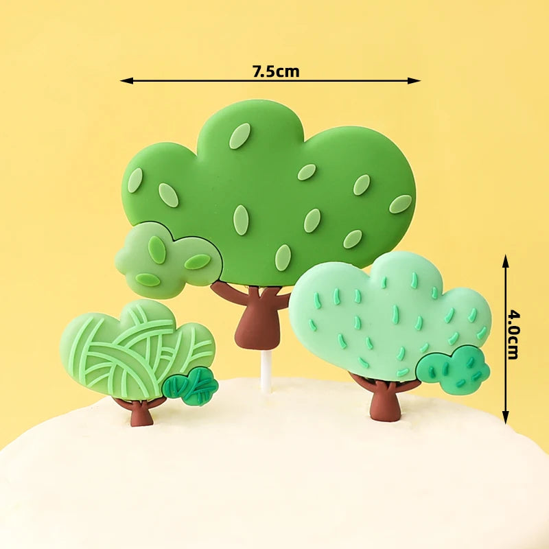 Green tree cake topper with leaves and a trunk on a white cake.