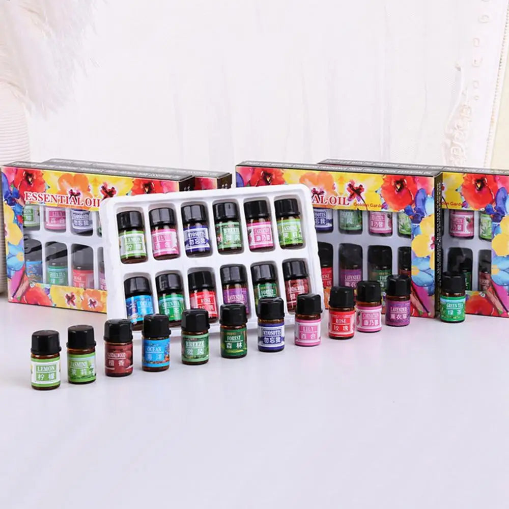 A set of essential oils in small glass bottles displayed in colorful cardboard boxes.